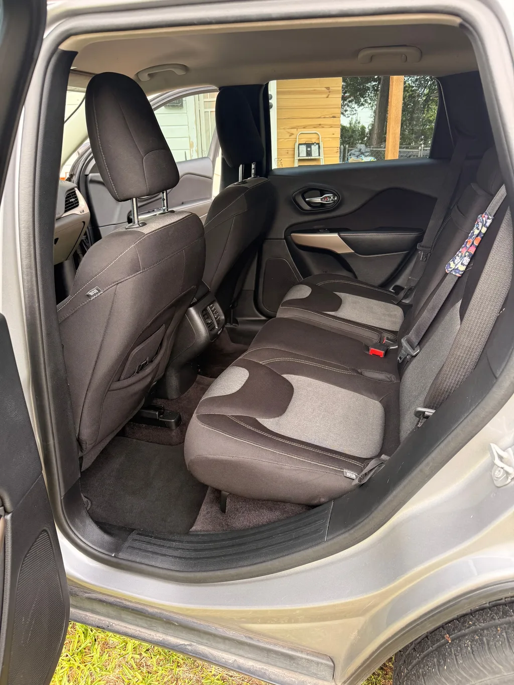 Rear seat of the silver Jeep Cherokee after an interior detail, child seats out, cloth seats and floor clean and empty